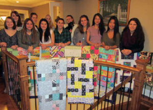 Burnaby Girls U17 Soccer Team with quilts donated by Lions Gate members